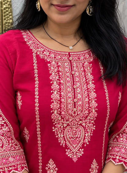 Pink, blush and ivory embroidery detail on a magenta kurta