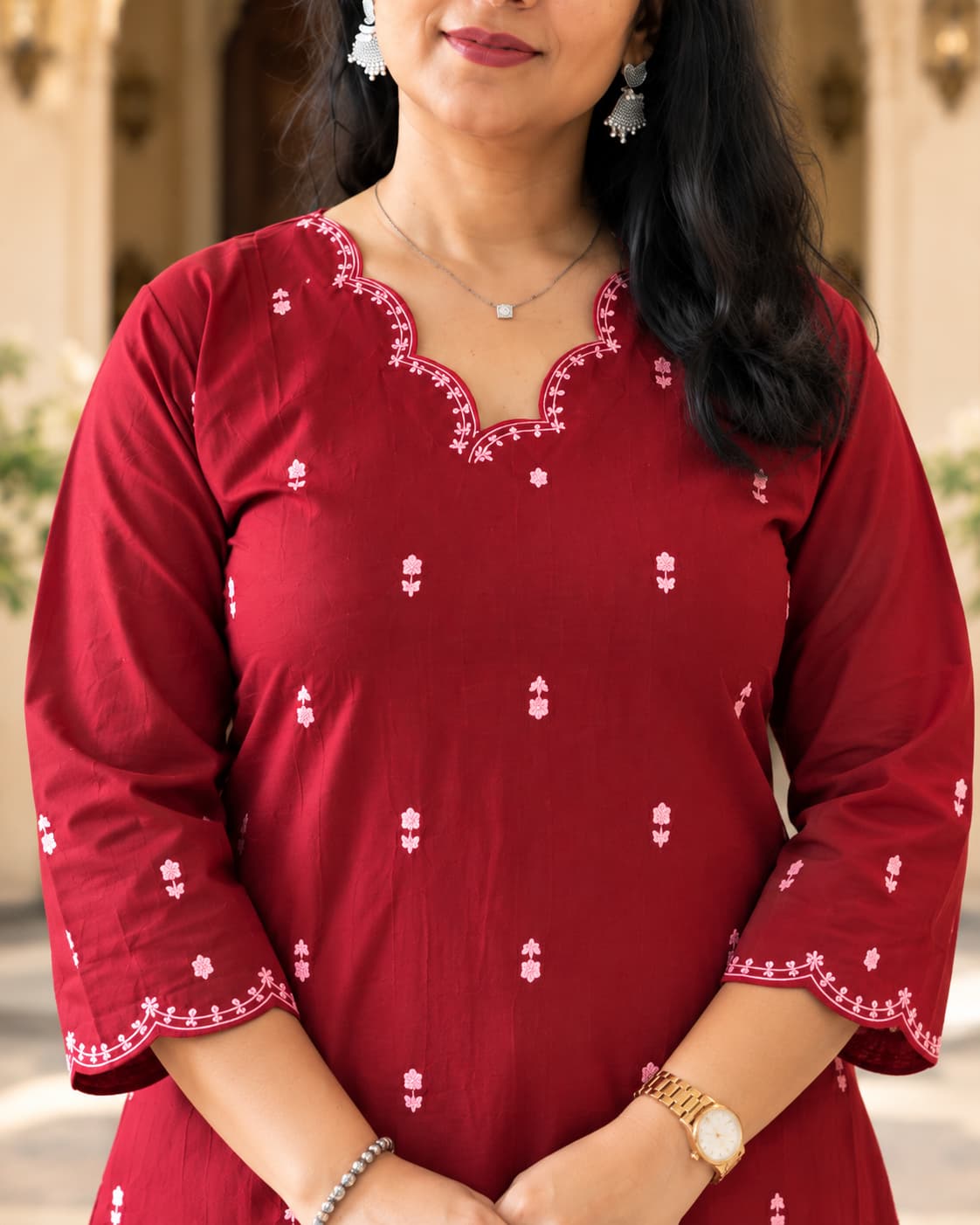 Embroidered sleeve border on a maroon cotton kurta