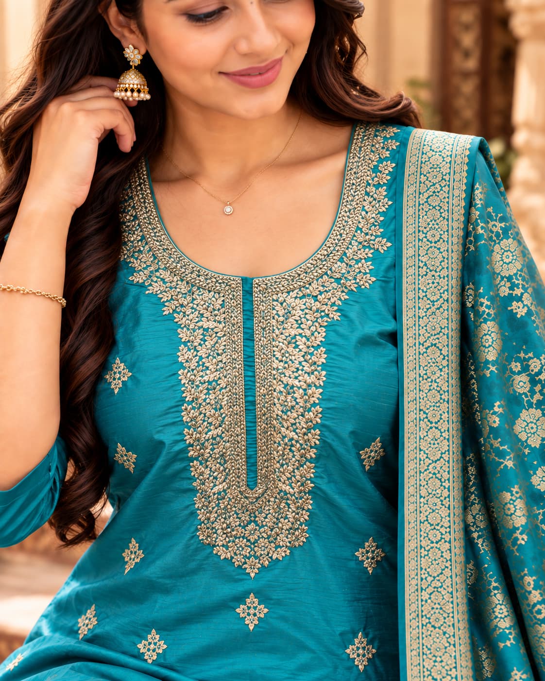 Embroidered front panel and round neckline on a teal blue kurta
