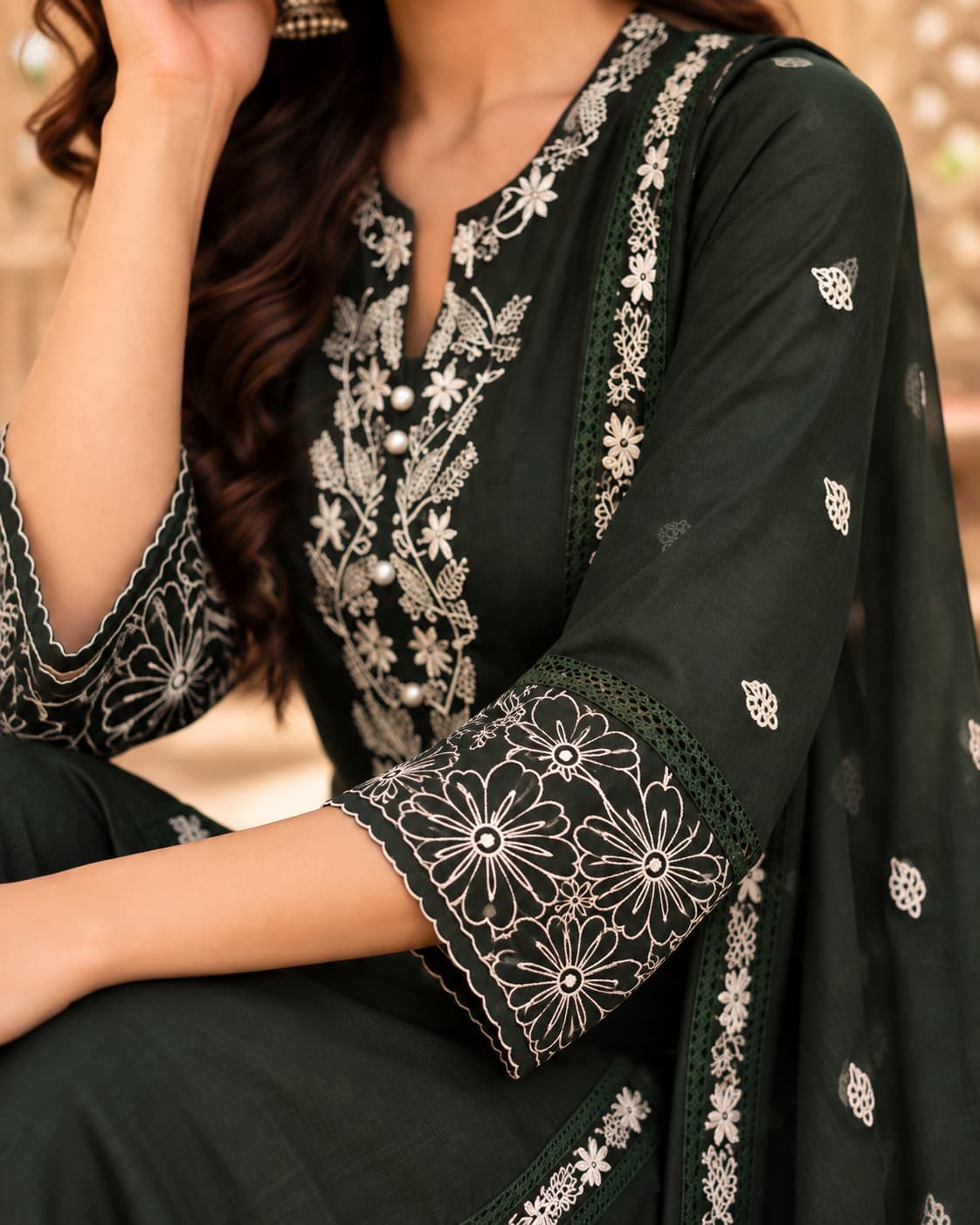 Three-quarter sleeves with embroidered cuffs on a green kurta