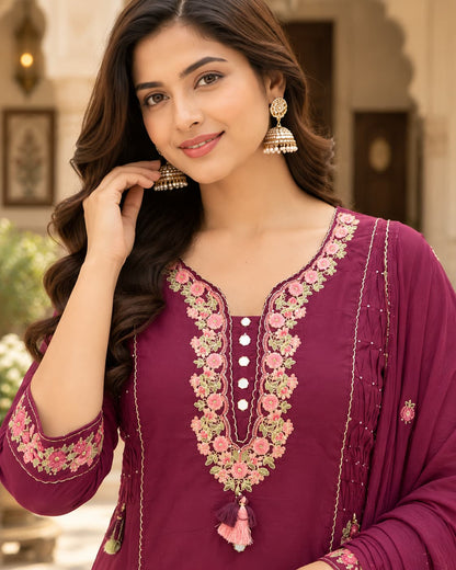 Pink and green floral embroidery detail on a wine cotton kurta