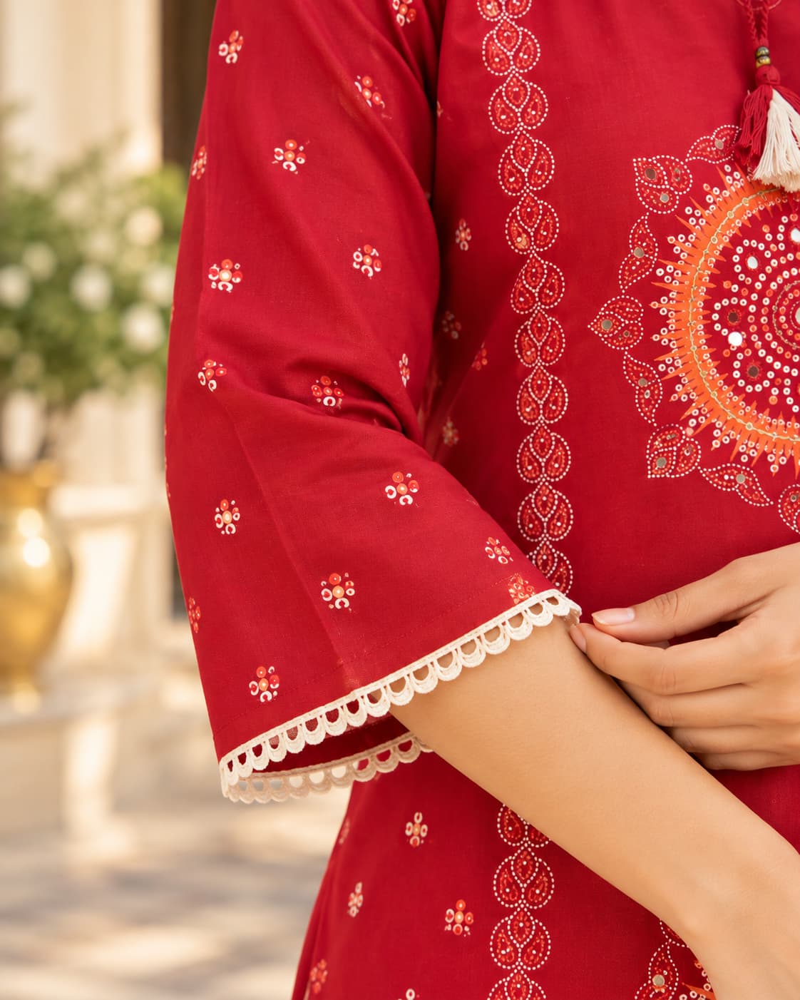 Mandala motif and mirror-look neckline detail on a red kurta
