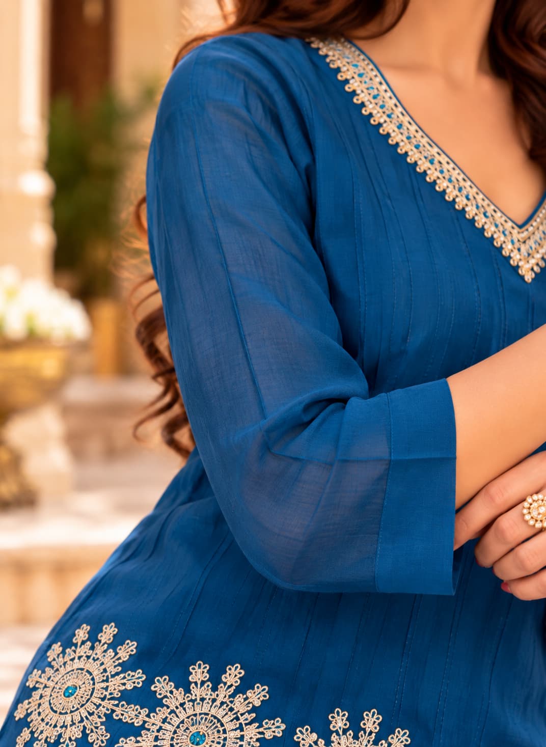 Scalloped hem with gold and ivory mandala embroidery on a teal kurti
