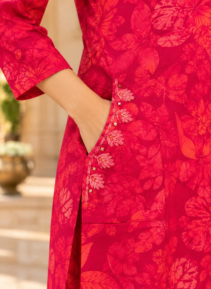 Embroidered side pocket detail on a fuchsia floral rayon kurta