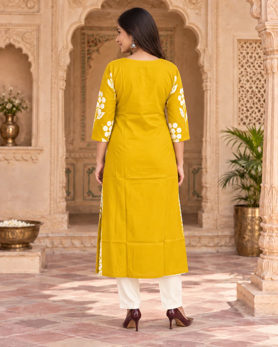 White floral embroidery detail on a mustard straight kurta