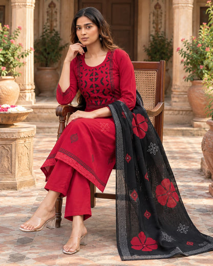 Red A-line cotton kurta with black Dabu-style motifs and appliqué neckline