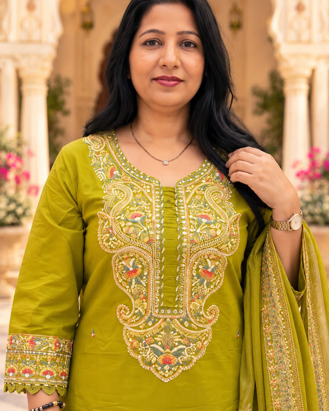 Woman wearing a mehendi green embroidered cotton kurta set with matching pant