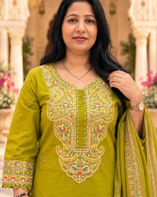 Woman wearing a mehendi green embroidered cotton kurta set with matching pant