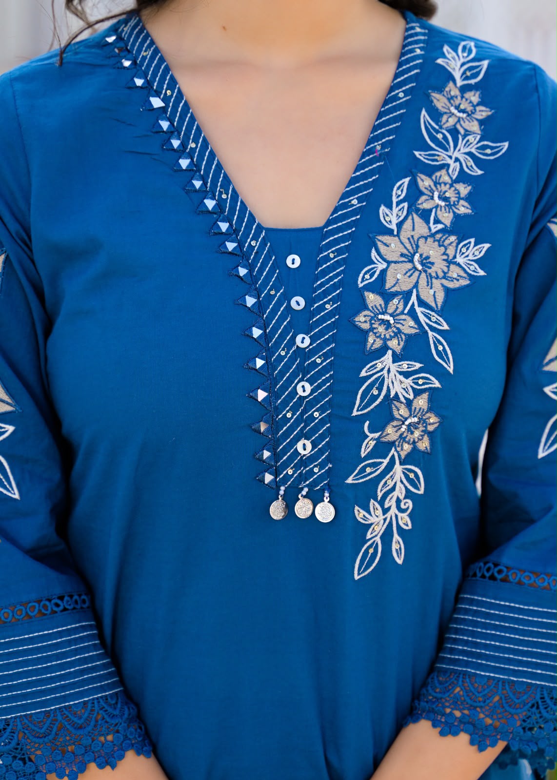 Blue floral embroidered kurta with detailed neckline and matching straight pants